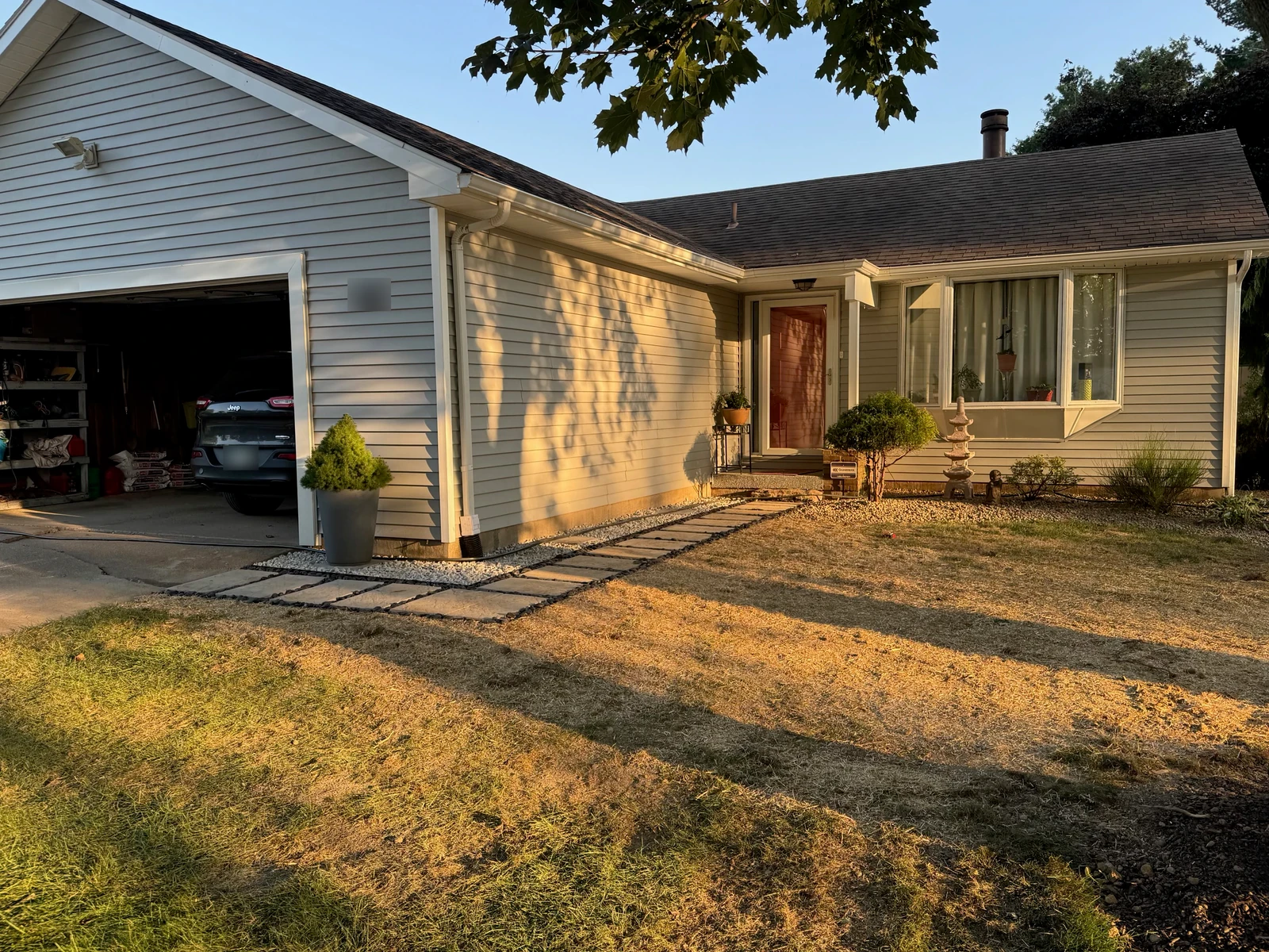 Finished stepping-stone walkway and decorative stone, with restored ground beside the home